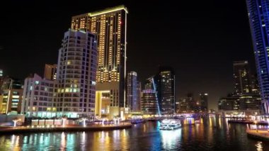 4K Dubai Limanı gece vardiyası, Birleşik Arap Emirlikleri. Dubai Marina, dünyanın en büyük insan yapımı marinası. Dubai Marina, Basra Körfezi 'nin 3 km' lik bir kıyı şeridi boyunca oyulmuş bir kanal kentidir.