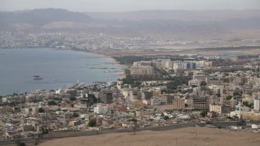 Ürdün 'deki Akabe şehri Panorama ve İsrail' deki Eilat şehri. Ürdün 'ün Akabe şehrindeki dağdan manzara. Bir video klipte iki şehir ve iki ülke
