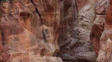 The Siq - narrow passage, gorge that leads to Red Rose City Of Petra, originally known to Nabataeans as Raqmu - historical and archaeological city in Hashemite Kingdom of Jordan