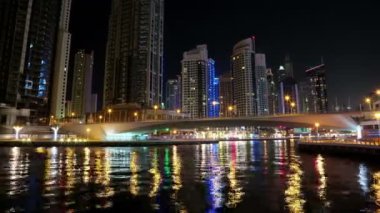 4K Dubai Limanı gece vardiyası, Birleşik Arap Emirlikleri. Dubai Marina, dünyanın en büyük insan yapımı marinası. Dubai Marina, Basra Körfezi 'nin 3 km' lik bir kıyı şeridi boyunca oyulmuş bir kanal kentidir.