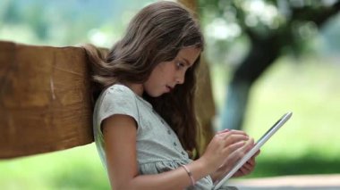 Tablet bilgisayarı olan kız. Tablet PC 'de güzel bir kız oyunu oynuyor. Tablet-PC 'si olan hoş bir kız bankta oturuyor. Gerçek samimi duygular. Tablet bilgisayarı olan güzel bir kız. Oyundan büyülenmişti.