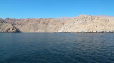 Gemi Musandam yarımadası boyunca ilerliyor, Umman Sultanı, Umman Körfezi. Umman - Arap Yarımadası 'nın güneydoğu kıyısındaki Arap ülkesi. Musandam - Musandam yarımadasında bulunan Umman Valiliği