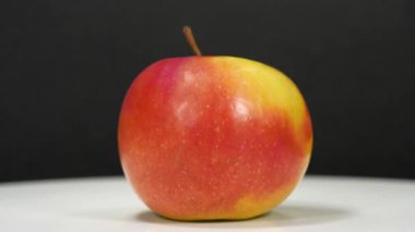 Olgun kırmızı elma siyah arkaplanda hızlı döner