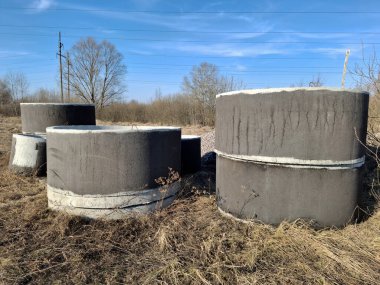 Reinforced concrete rings of different diameters for construction work. Reinforced concrete rings are special structures for the construction of wells. Water supply and sewerage, outdoor shot photo
