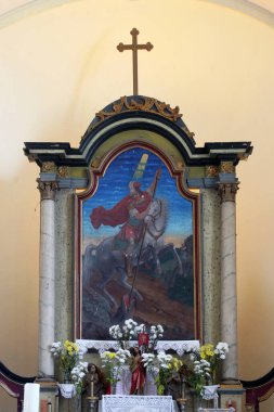 Saint George slays the dragon, main altar in the parish church of Saint George in Durdic, Croatia
