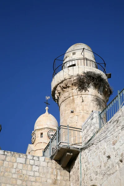The Benedictine Dormition Abbey bell tower stands parallel to a Muslim mosque minaret built atop the the King David\'s Tomb in Jerusalem, Israel