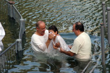 Baptismal site at Jordan river shore. Baptism of pilgrims in Yardenit, Israel on September 30, 2006. clipart