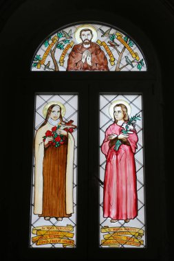 Saints Therese of Lisieux and Maria Goretti, stained glass window in the parish Church of the Immaculate Heart of Mary in Ilova, Croatia clipart