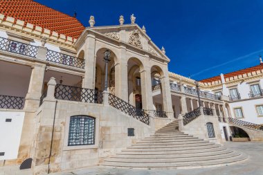 A grand stone staircase leads up to an ornate building with arched entryways and a red-tiled roof under a bright blue sky. clipart