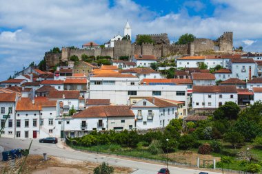 Terracotta çatılarının bir araya getirildiği geleneksel beyaz duvarlı evlerin karışımı ile Penela kasabasının büyüleyici bir manzarası. Kasabanın üstünde taş duvarları olan tarihi bir kale duruyor. Sahneye ortaçağ dokunuşu katıyor.