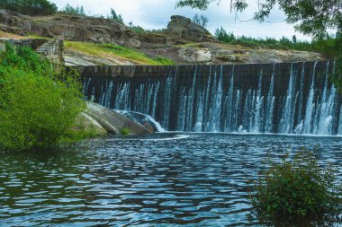 Suyun yumuşak çağlayanlarla aktığı taş baraj.