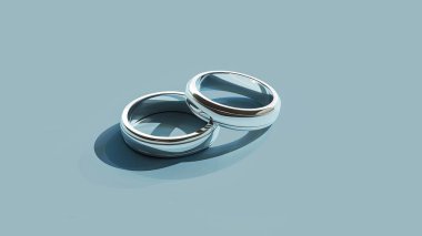 Minimalistic wedding rings in flat design set against a pastel blue background clipart