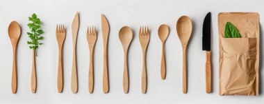 Biodegradable cutlery displayed on a white background, showcasing eco-friendly simplicity and cleanliness. clipart