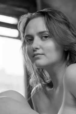 Portrait of a young attractive naked brown-haired girl close-up
