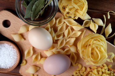 Pasta from durum wheat with the addition of chicken eggs on a cutting board close-up