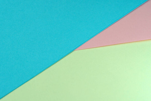 Sheets of colored paper lie at an angle, stationery background, macro