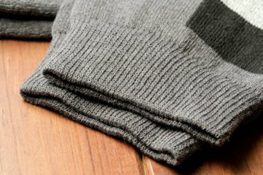 Kalıplı gri kollar ahşap bir masada uzanıyor, sıcaklığı ve rahatlığı davet ediyor..