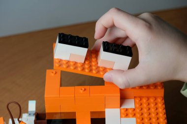 Turuncu yapı taşları kullanarak yaratıcı bir projeye girişmek.