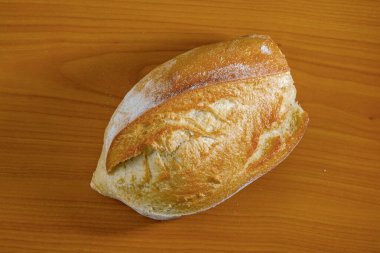 Altın-kahverengi zanaatkar ekmek kıtır kıtır ve yumuşak iç yüzünü sergiliyor..