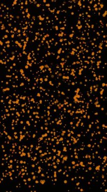 Canlı turuncu noktaların kıvrımlarını ve siyah bir arka planda parıltılarını izle..