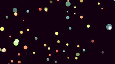 Bright and colorful bubbles float gently in the night, creating a magical atmosphere.