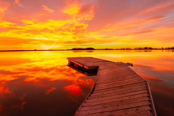 stock image A brilliant colorful sunrise as the fishing dock awaits the sun