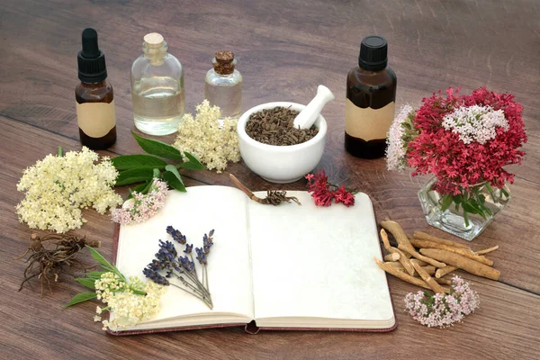 Naturopathic herbal plant medicine preparation with valerian root, lavender, elderflower and ashwagandha. For old fashioned traditional alternative flower remedies. On rustic wood.