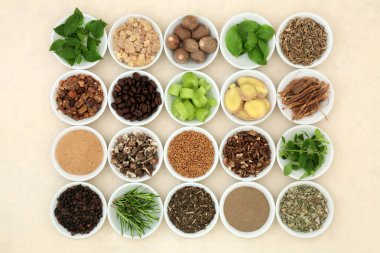 Nervine health food collection in bowls. Used to support and stimulate the nervous system. Healthy natural alternative health care. On hemp paper background.