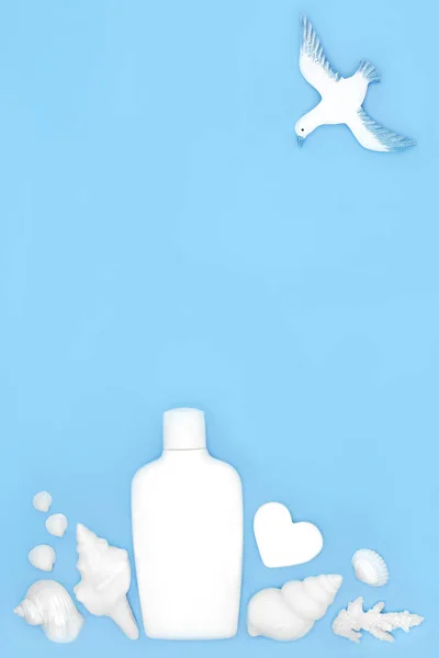 Summer suntan lotion for natural skincare with seashell soaps, shells and seagull on blue background. Fun natural design for the holiday season.