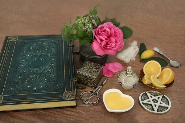 用玫瑰花 石英晶体 百里香 柠檬果 蜂蜜和魔法书配料准备魔咒的爱情药水 巫术秘方法术 免版税图库照片