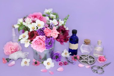 Flowers and herbs preparation for herbal remedies. Flower essences with quartz crystal for alternative medicine on lilac background. Wicca occult natural medicinal healing concept. clipart