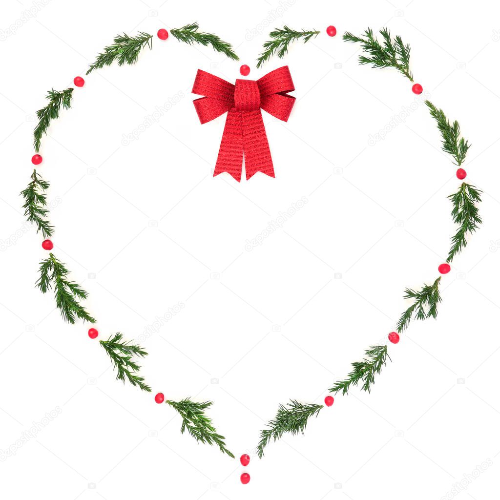 Christmas  heart wreath with fir, red bow and winter holly berries on white. Solstice decorative symbol of love for holiday season, gift tag, invitation, logo, card