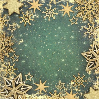 Christmas gold star snowflake decorations on grunge green background border. Festive holiday season fantasy magical decorative design for Xmas New Year, Yule, Noel.   clipart