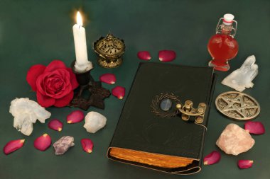 Witchcraft love potion concept with rose flower, petals, magical equipment with book of spells, crystals, heart shaped bottle for concoction. Ancient preparation occult wicca tradition. clipart