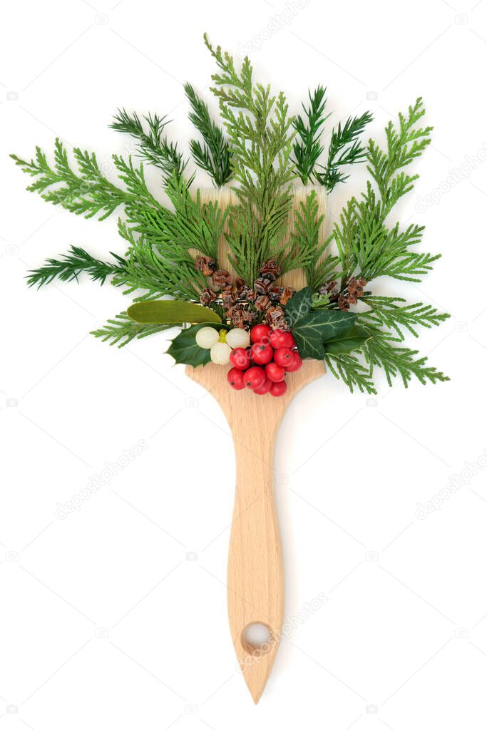Christmas painting with holly berries, mistletoe and winter greenery with paintbrush on white background Festive surreal abstract design for logo symbol, greeting card.
