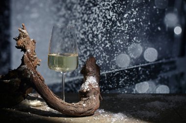 Closeup Glass of White Wine and snow at Winter Window