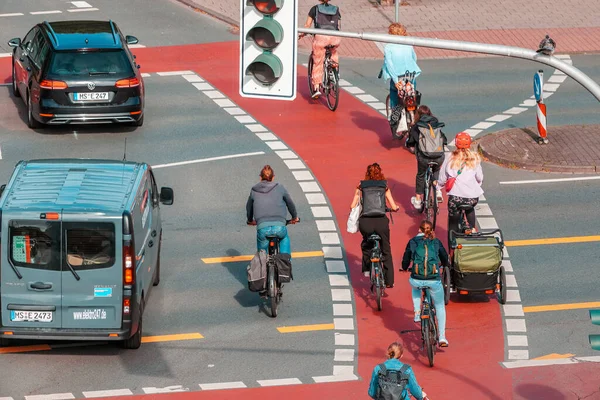 stock image 26 July 2022, Munster, Germany: Cyclists ride along the bike path on the city streets crossroad. Road safety infrastructure and eco-friendly transport in the city