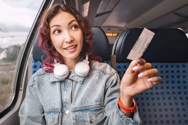 stock image The girl shows her train ticket to the controller. Prices for travel and tourism transport