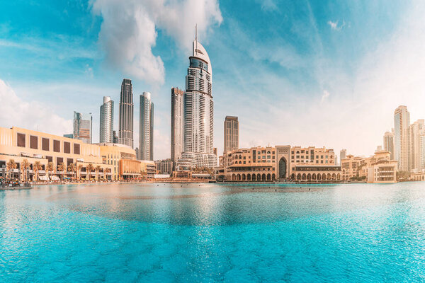 Water pond near the entrance to Dubai Mall and on promenade embankment with skyscrapers in the background