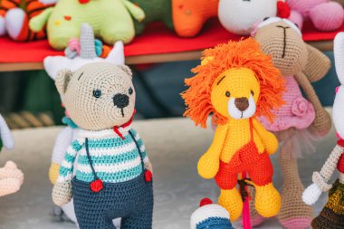 Various knitted funny toys for children are sold at the hand made market
