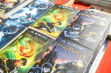 28 October 2022: Antalya, Turkey: Harry Potter book in hand at turkish books fair clipart