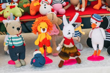 Various knitted funny toys for children are sold at the hand made market