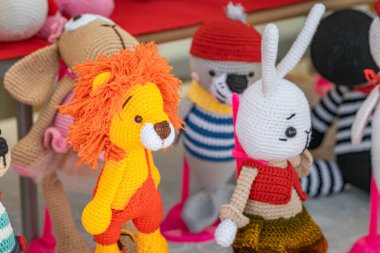 Various knitted funny toys for children are sold at the hand made market