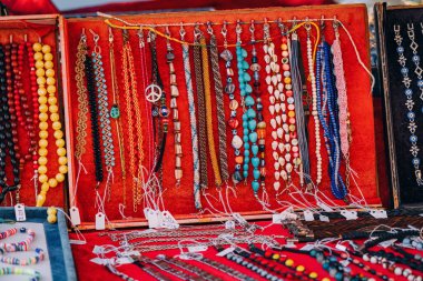 Trendy handmade leather bracelets and wristbands for sale at artisans market. Handcraft souvenir at flea market. Purchase of elegant souvenirs