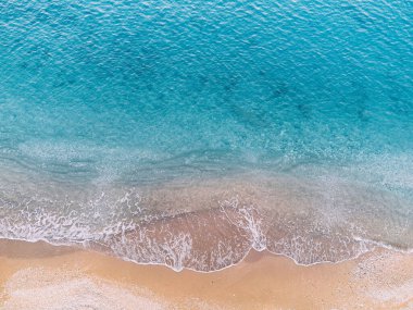 Hava manzarası nefes kesici bir plaj cenneti sergiliyor, izleyicileri rüya gibi bir tatil kaçışına davet ediyor. Yukarıdan bakıldığında, turkuaz sularla karşılaşan el değmemiş bir altın kum tabakası görülüyor..