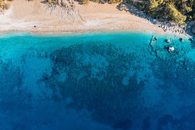 An aerial view reveals a breathtaking beach paradise, beckoning viewers to indulge in a dreamy vacation getaway.