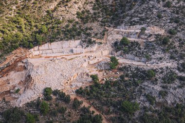 aerial view of a marble quarry, revealing the industrial nature of marble extraction.
