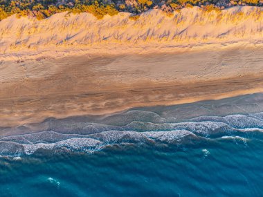 An aerial view reveals a breathtaking beach paradise, beckoning viewers to indulge in a dreamy vacation getaway.