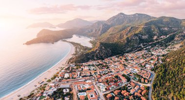 Aerial view of a resort town Oludeniz in Turkiye at sunset. Travel landmarks and destinations