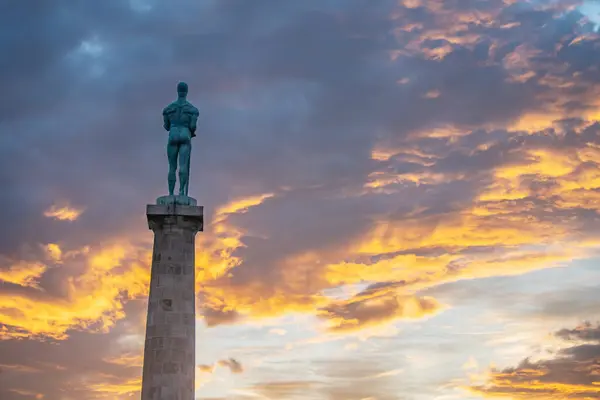 Explore Belgrade's cultural heritage at Kalemegdan: The Pobednik Statue at sunset